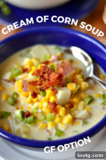 A bowl of creamy corn soup, garnished with fresh herbs and a swirl of liquid