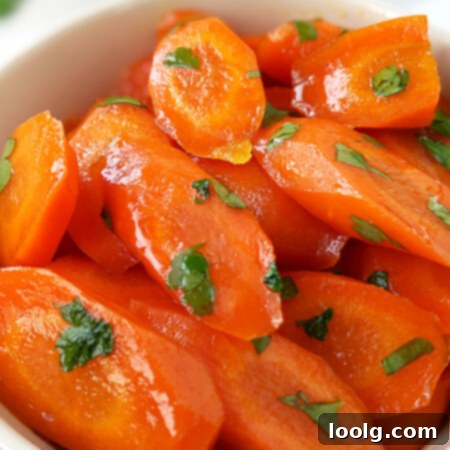 image of a bowl full of bright orange glazed carrots garnished with green parsley