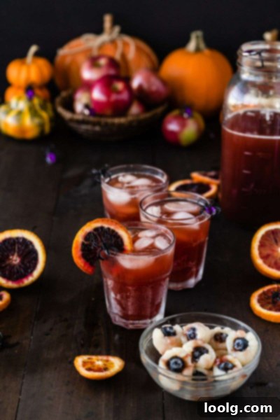Close-up of Halloween punch in a glass, with lychee eyeballs and a spider decoration
