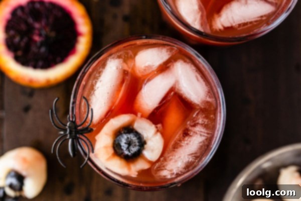 Overhead shot of Halloween punch with lychee eyeballs and festive decorations