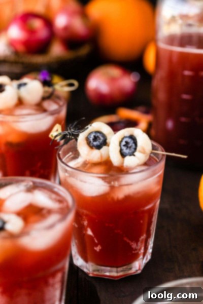 Glasses of Halloween punch garnished with lychee eyeballs, ready to serve