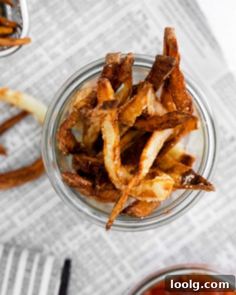 Patting potato fries dry with paper towel