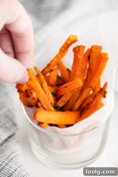 hand picking up air fryer carrot fries