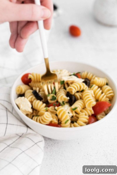 fork picking up some greek pasta salad