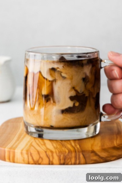 hand holding cup of pumpkin coffee