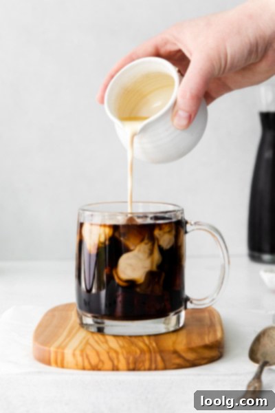 pumpkin foam being poured into coffee
