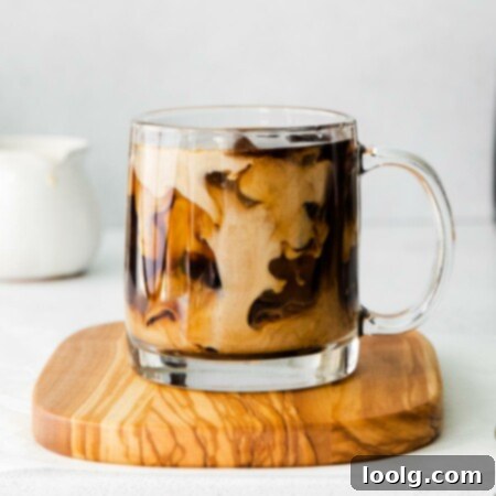 cup on coaster with pumpkin cold brew