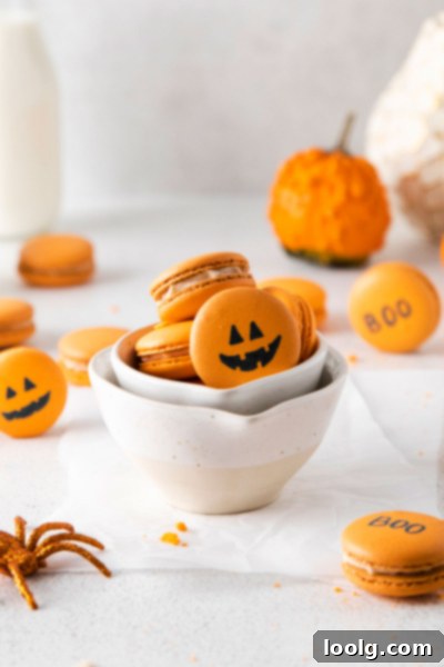 Stacked pumpkin spice macarons with decorative elements.
