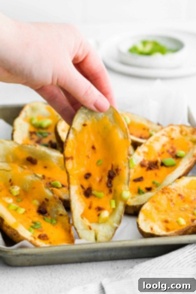 Air Fryer Potato Skins loaded with melted cheddar cheese, crispy bacon, and chopped chives.
