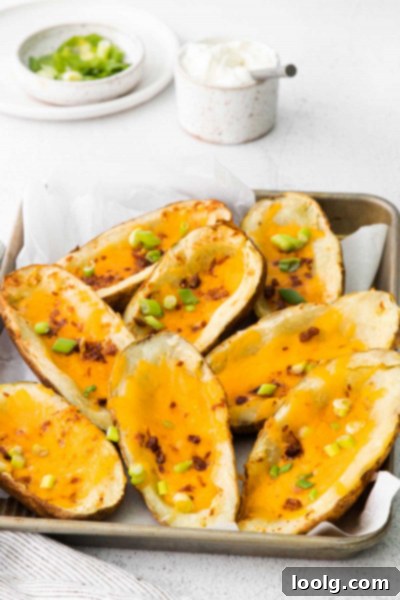 A single Air Fryer Potato Skin half, golden brown and crispy, ready to be filled.
