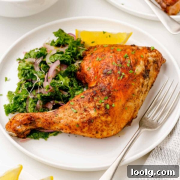 Air fryer chicken quarters with roasted vegetables on a plate