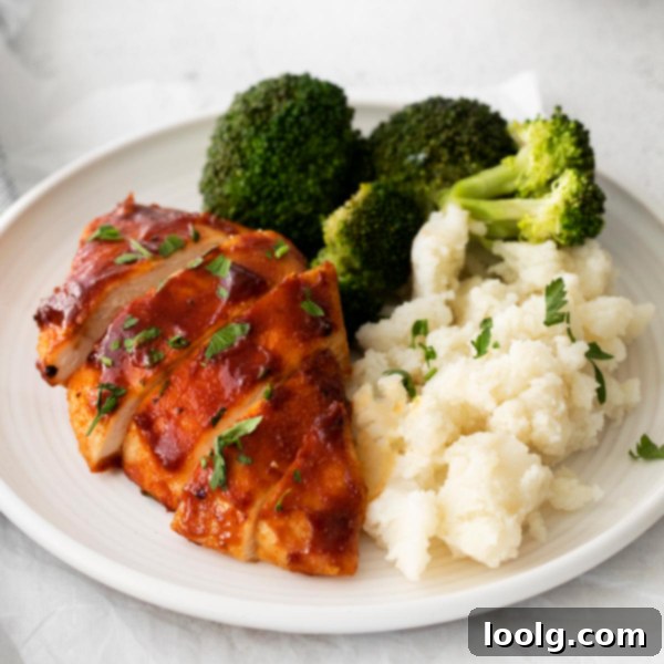 Plate of air fryer BBQ chicken served with fresh vegetables