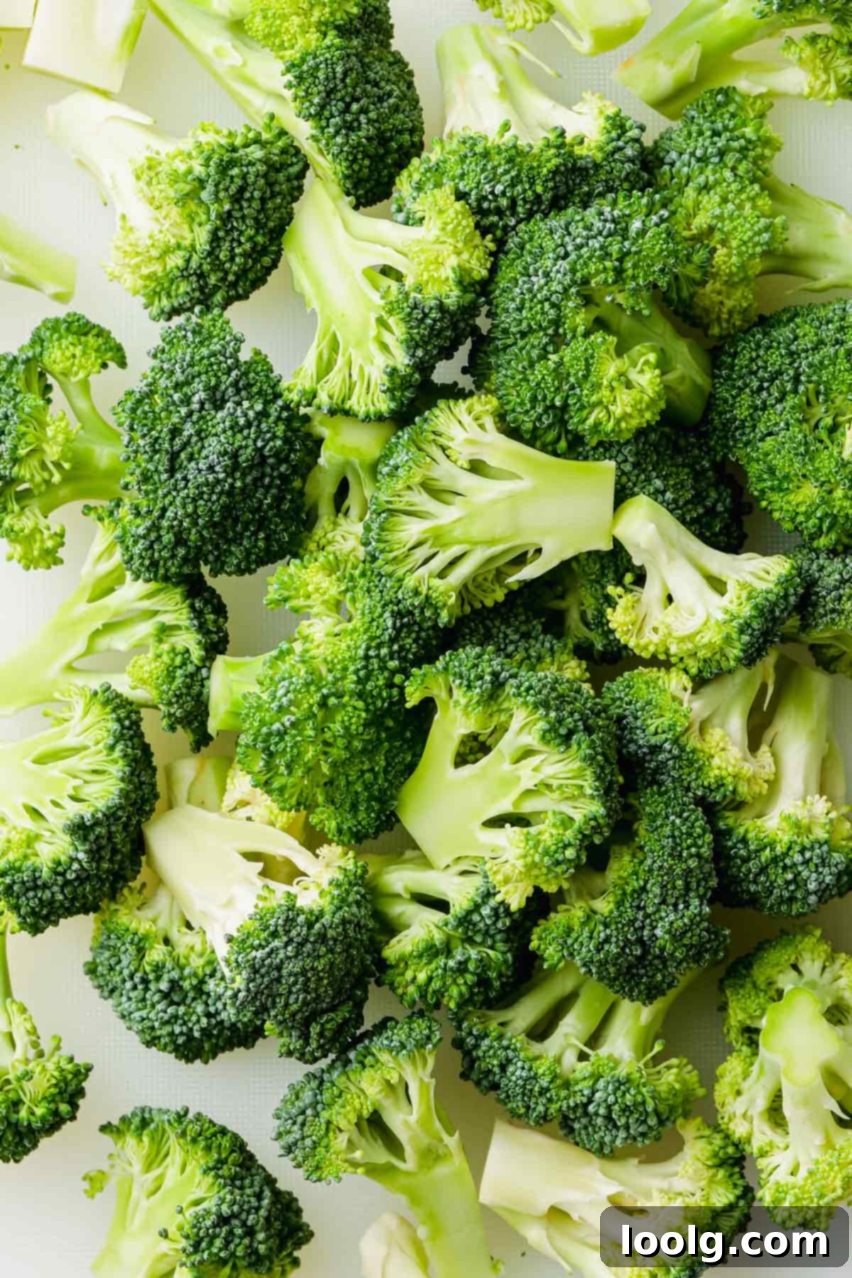broccoli florets on white cutting board