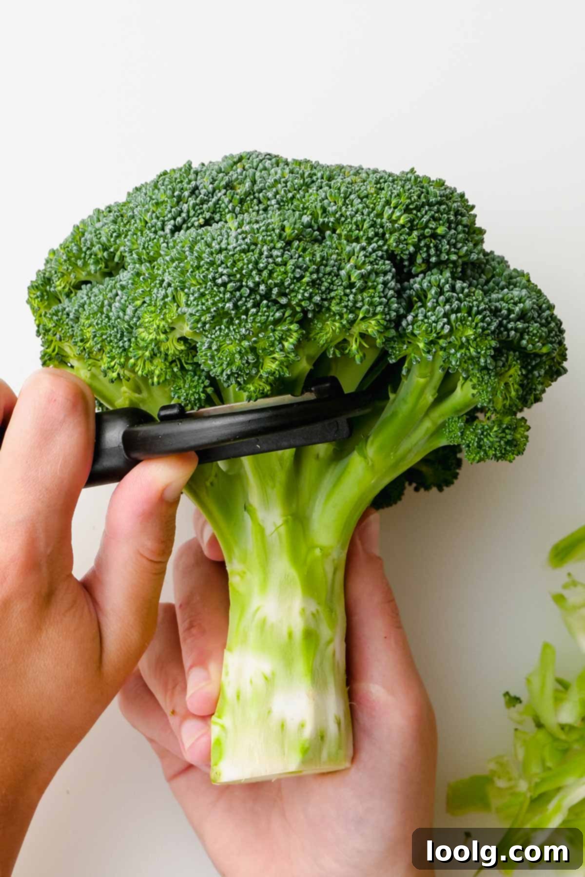 broccoli head being peeled