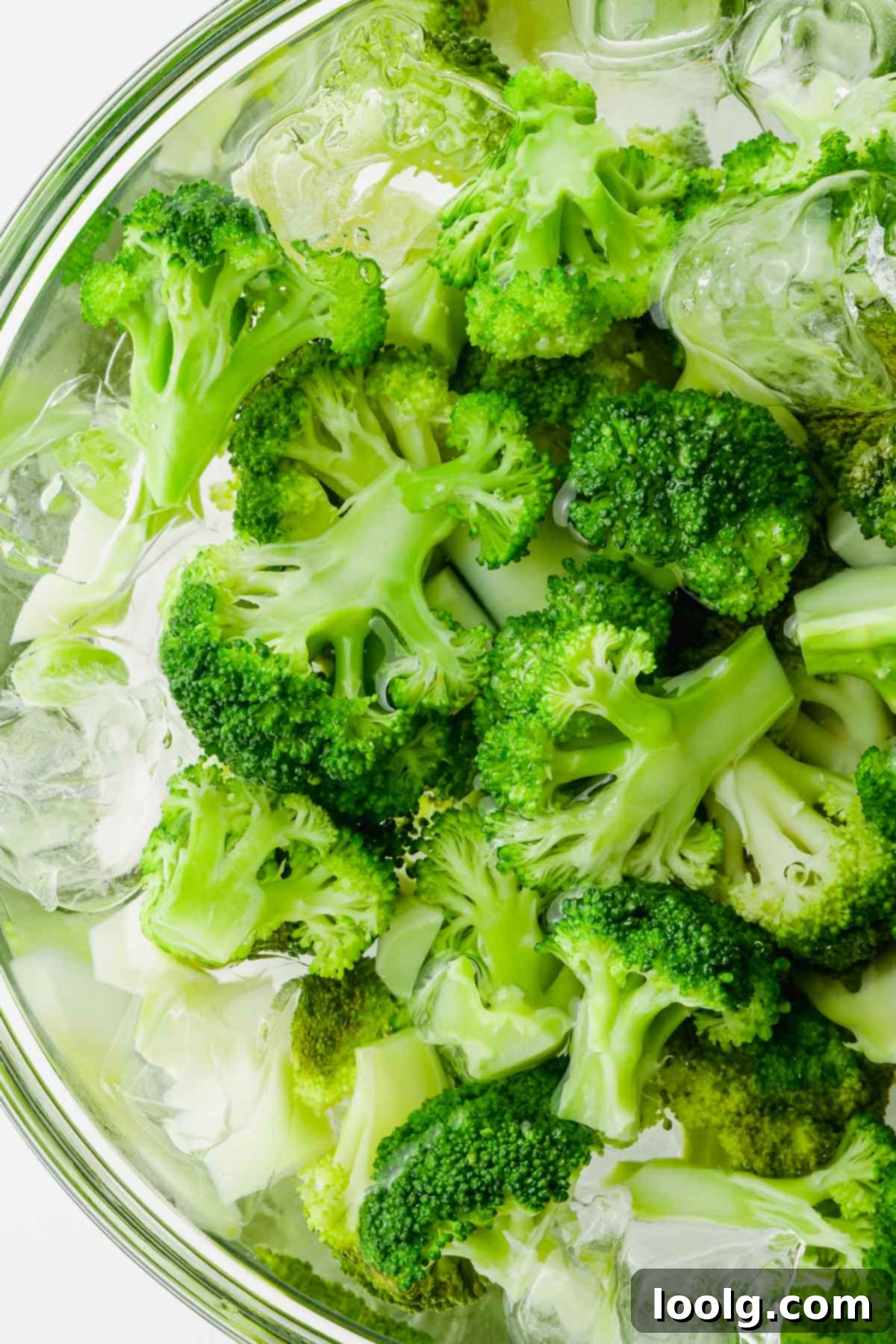 broccoli florets in bowl of ice water after boiling
