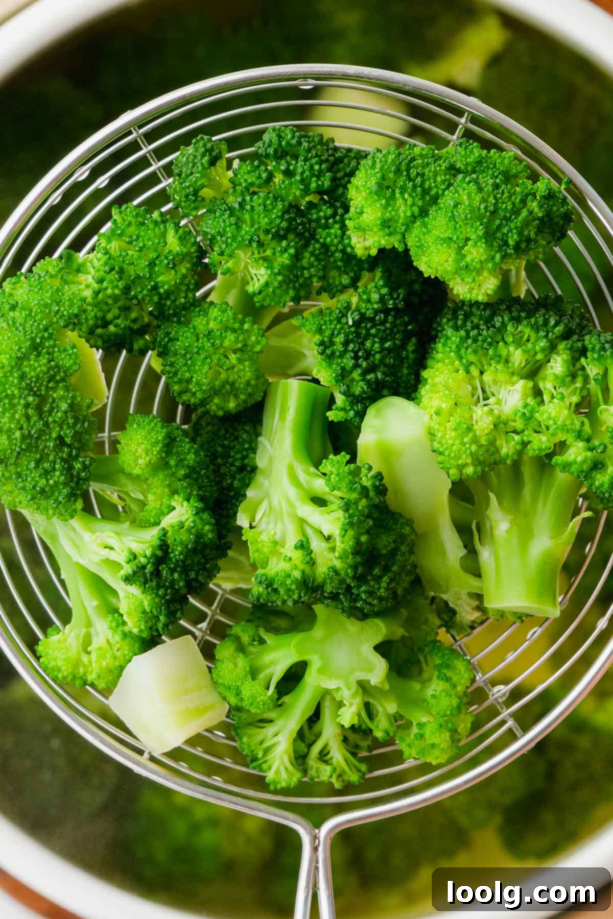 broccoli being removed from boiling pot