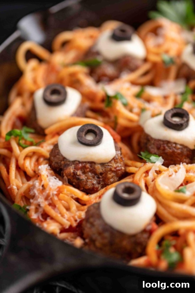 Halloween meatballs on spaghetti served in a pan