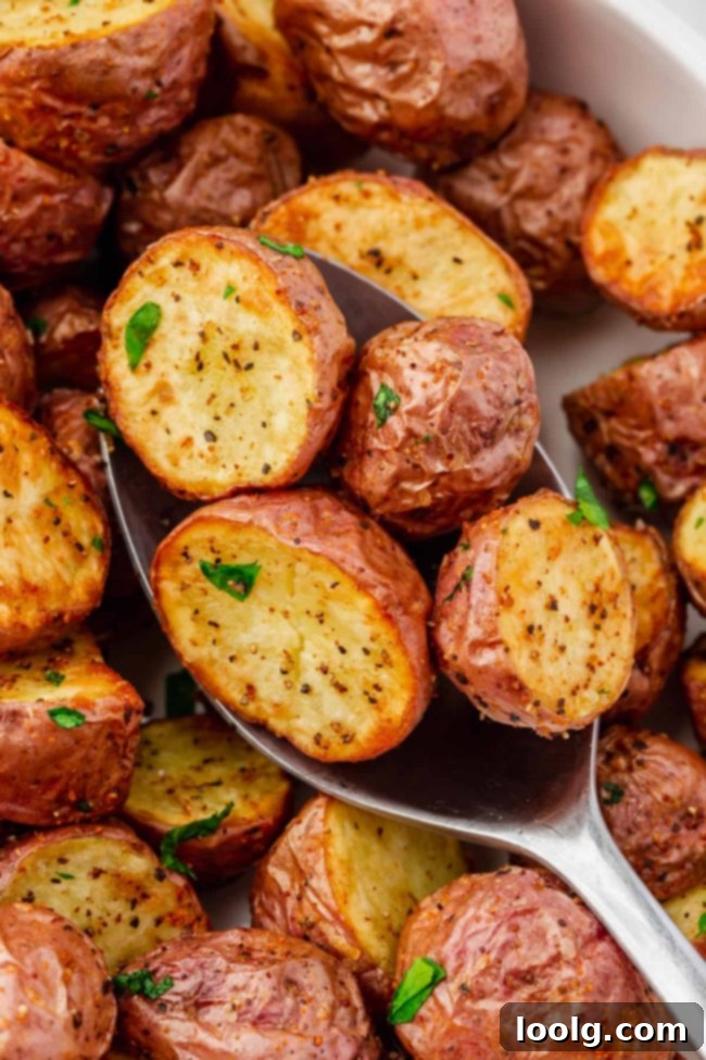 Air fryer red potatoes, perfectly golden and crispy, garnished with fresh herbs, ready to be served as a delicious side dish.