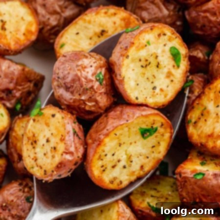 Close-up photo of crispy, halved red potatoes cooked in an air fryer.