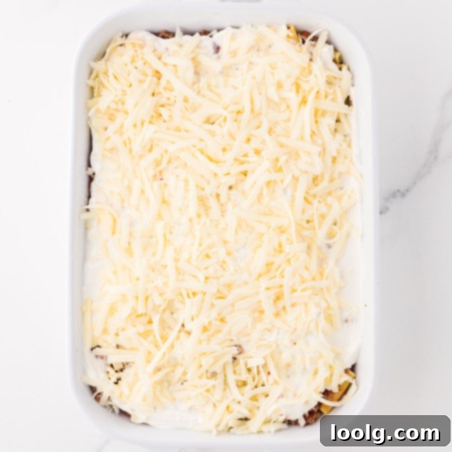 mozzarella being spread over the sour cream