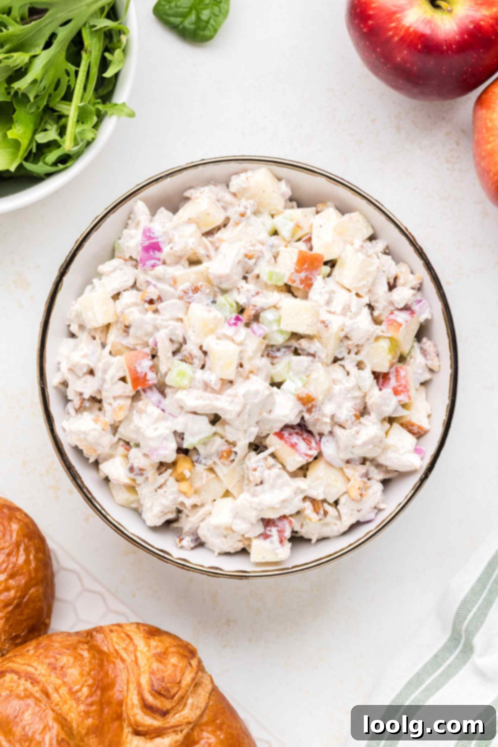 A crisp and creamy apple walnut chicken salad in a white bowl, ready to serve