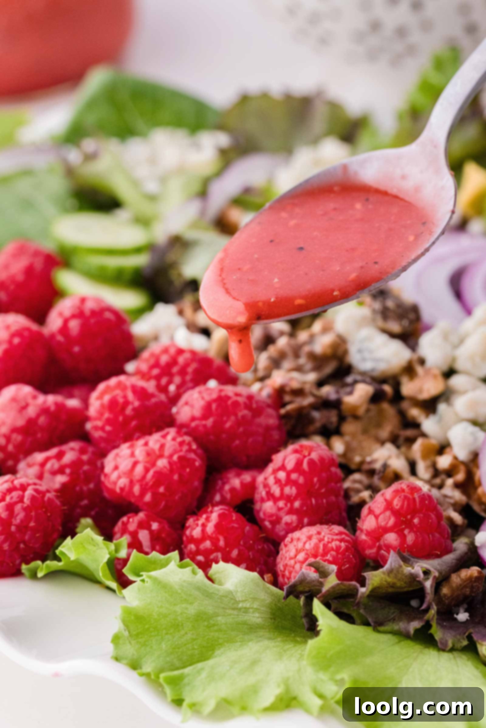 spoon drizzling vinaigrette over a salad