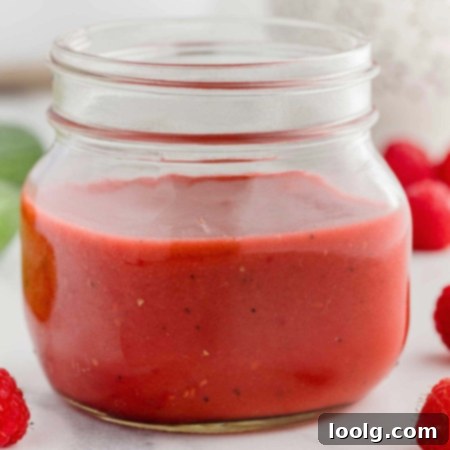 Ruby Raspberry Dressing 6 raspberry vinaigrette in a clear jar with raspberries in the background