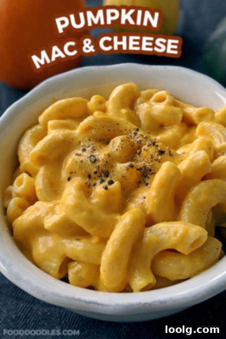 Creamy pumpkin mac and cheese in a rustic bowl, garnished with a sprinkle of fresh herbs.