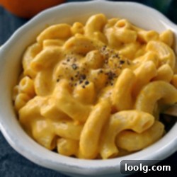 A bowl filled with rich, creamy pumpkin mac and cheese, ready to be enjoyed.
