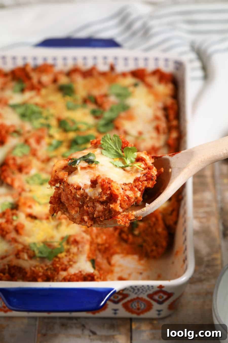 Close-up of baked quinoa pizza casserole with golden, crispy edges and melted cheese.