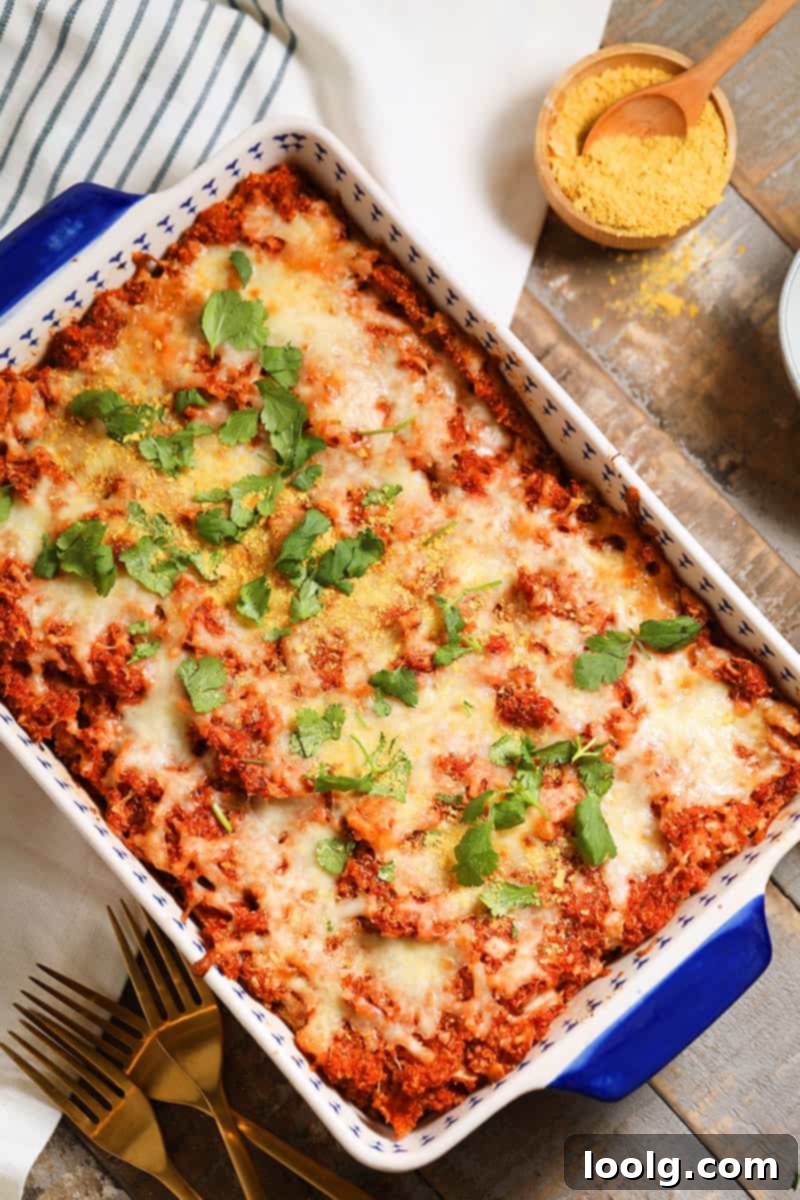 Quinoa pizza casserole topped with fresh herbs, showcasing its rich texture and appetizing appeal.