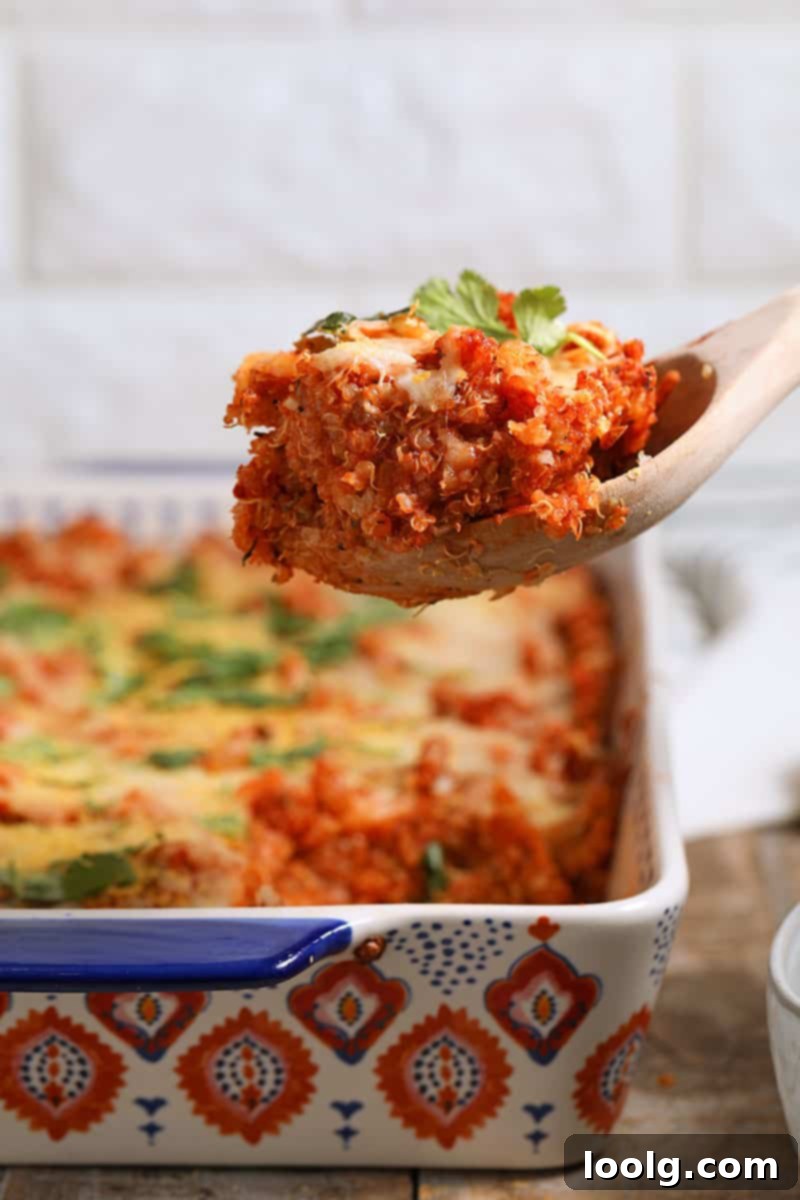 A serving of Quinoa Pizza Casserole, showcasing its baked texture, melted cheese (or nutritional yeast), and readiness to be enjoyed. Gluten-free and vegan adaptable.
