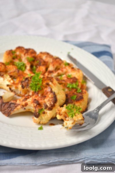 Close-up of a perfectly roasted Cajun cauliflower steak, featuring a golden-brown exterior and crispy edges.