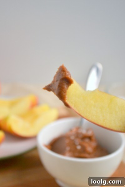 Drizzled raw vegan caramel over apple slices, ready for toppings
