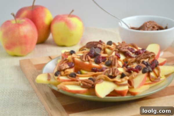 A close-up of a loaded apple nacho with drizzles and sprinkles