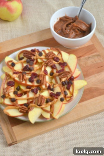Another view of a colorful plate of apple nachos topped with caramel and nuts