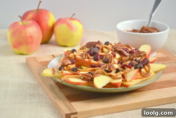 A hand reaching for a piece of apple nacho, showcasing its appealing texture