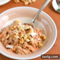 A top-down shot of Carrot Cake Overnight Oats, garnished with crunchy walnuts and delicate coconut flakes.