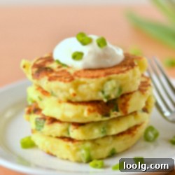 Mashed Potato Makeover: Crispy Pancakes 1 image of a stack of mashed potato pancakes topped with sour cream and chives