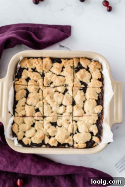 Ruby Red Cranberry Shortbread Gems 3 Cranberry Shortbread Bars in an 8x8 baking pan, showing the crust and filling layers