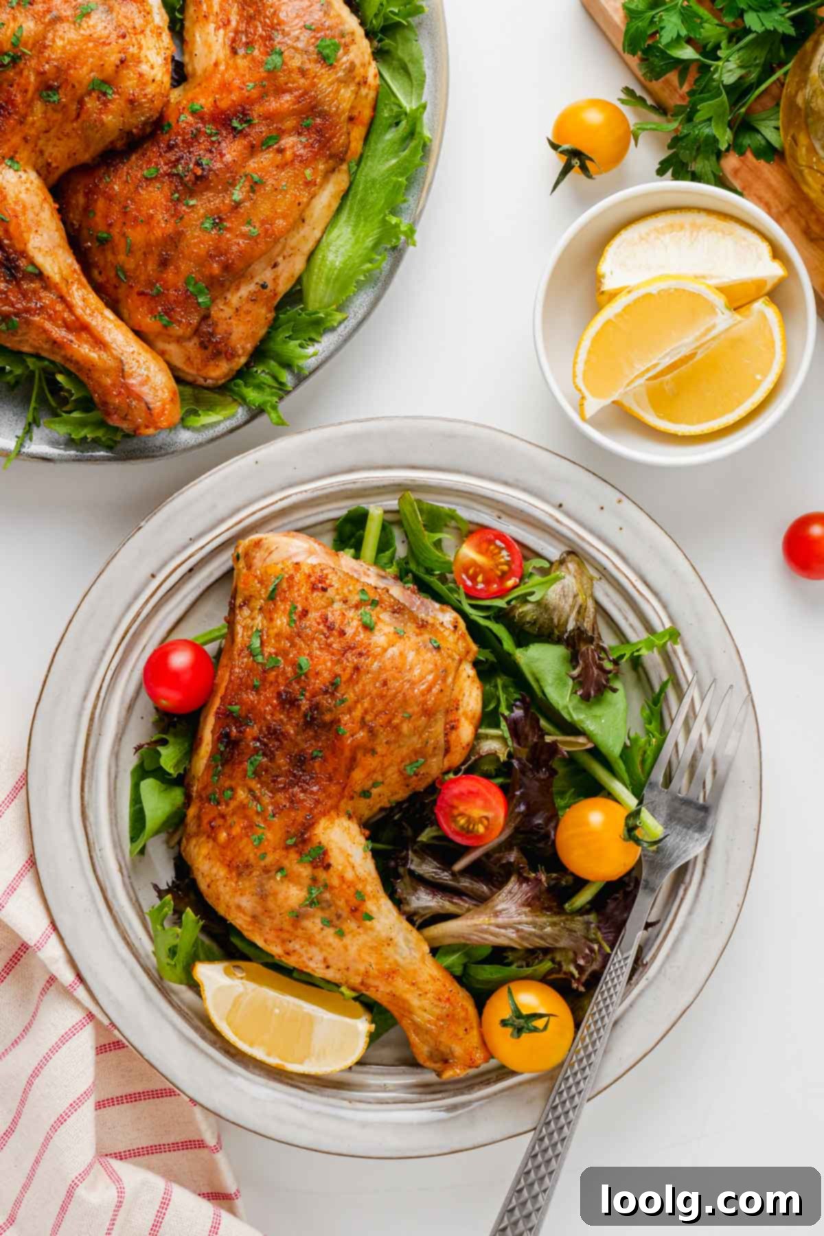 Effortless Five Ingredient Chicken Leg Quarters 9 plate with salad and a chicken leg quarter on it