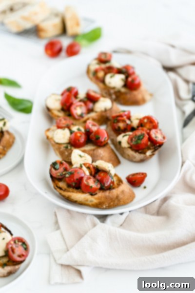 Sun-Ripened Tomato Mozzarella Bruschetta 3 Close-up of sliced cherry tomatoes on a cutting board, ready for bruschetta