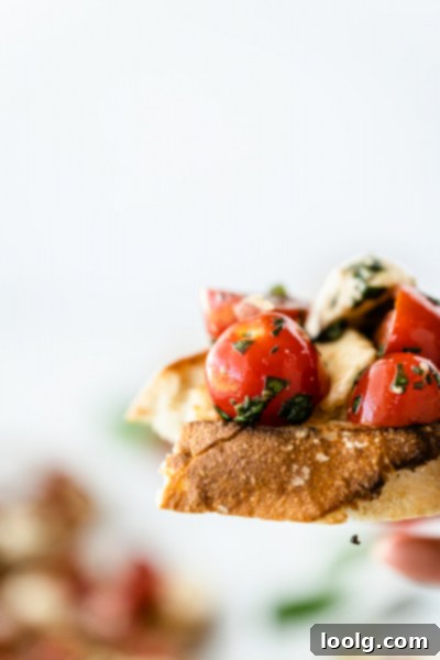 Sun-Ripened Tomato Mozzarella Bruschetta 6 Finished bruschetta with mozzarella and tomatoes on a white platter