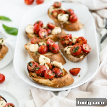 Sun-Ripened Tomato Mozzarella Bruschetta 8 Photo of toasted bruschetta with mozzarella and halved cherry tomatoes with fresh basil and a little oil on a white platter