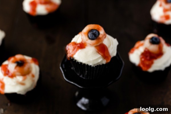 Ghoulish Gaze Cupcakes 4 Three chocolate cupcakes frosted with white cream cheese frosting, ready for the lychee eyeballs.