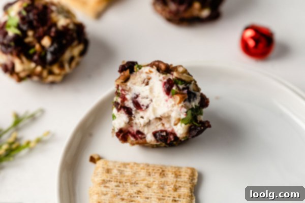 Tangy Goat Cheese Truffles 5 Goat Cheese Balls on a serving board with various crackers