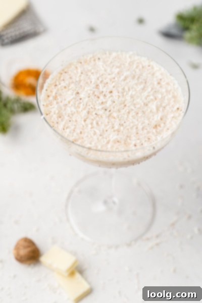Frosted Yuletide Delight 2 White Christmas Cocktail in cocktail glass, garnished with shaved white chocolate