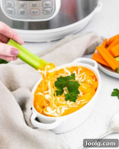 Ultimate Instant Pot Buffalo Chicken Dip 2 Creamy Instant Pot Buffalo Chicken Dip served in a bowl with a celery stick, perfect for a party