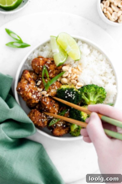 Crispy Air Fryer Sesame Chicken 4 Air fryer sesame chicken served in a bowl with chopsticks