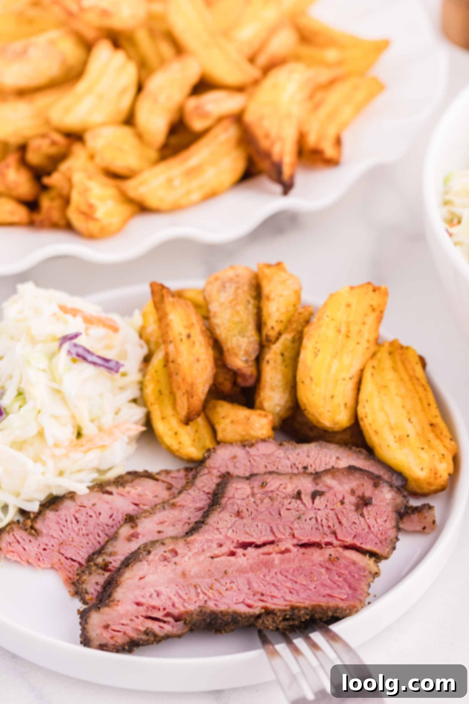 Slow-Smoked Corned Brisket 4 white plate filled with slices of corned beef, potato wedges and coleslaw